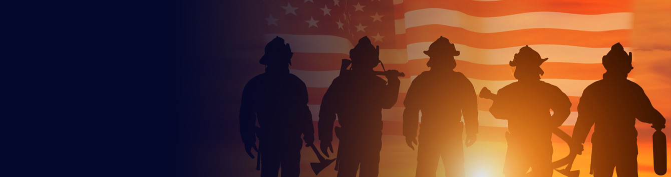 Firefighters in silhouette in front of an American flag and sunset